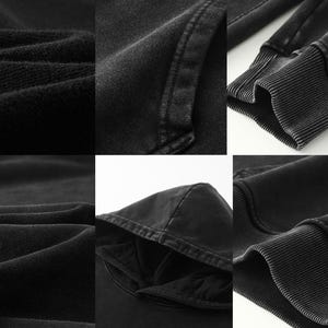 May include: Close-up of black fabric with a textured, slightly distressed look. The fabric is folded and shows the texture and stitching details.