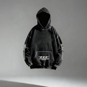 May include: Black hoodie with a front pocket and a hood. The hoodie has white text on the sleeves and a graphic on the front pocket that reads "UNDRGRND CULTURE". The hoodie is a dark, faded color.