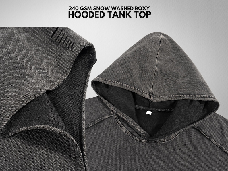 May include: A gray hooded tank top with a boxy fit. The top is made of a soft, washed cotton fabric. The hood is lined with a black fabric. The text "240 GSM SNOW WASHED BOXY HOODED TANK TOP" is printed on the top.