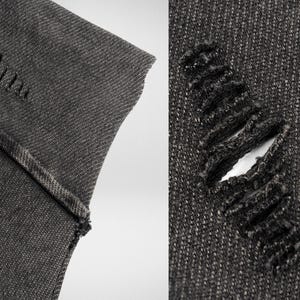 May include: Close-up of two pieces of dark gray denim fabric. One piece has a small hole and the other has a larger hole with frayed edges.