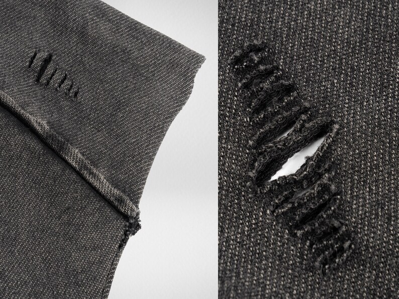 May include: Close-up of two pieces of dark gray denim fabric. One piece has a small hole and the other has a larger hole with frayed edges.