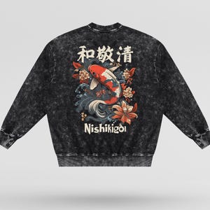 May include: Black acid wash sweatshirt featuring a Japanese koi fish design with the text "Nishikigoi" and Japanese characters. The design includes red, white, and blue koi fish, flowers, and waves. A long-sleeved, crew neck top.