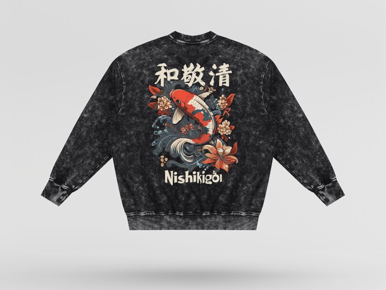 May include: Black acid wash sweatshirt featuring a Japanese koi fish design with the text "Nishikigoi" and Japanese characters. The design includes red, white, and blue koi fish, flowers, and waves. A long-sleeved, crew neck top.