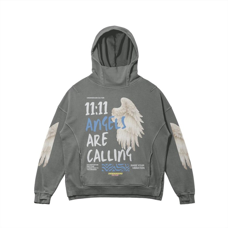 May include: A gray hooded sweatshirt with the text "11:11 Angels Are Calling" and angel wing graphics. The sweatshirt has a kangaroo pocket and a high collar. The sleeves also feature angel wing graphics.