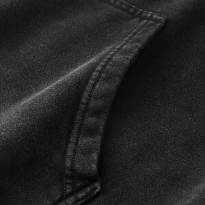 May include: A charcoal black hoodie featuring a washed, faded fabric texture. The garment includes a prominent kangaroo pocket on the front, defined by thick, reinforced double-stitched seams along the edges of the pocket opening.