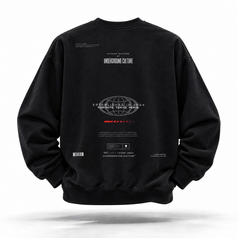 May include: A black long-sleeve sweatshirt featuring white graphic text and a globe icon on the back. The print includes the words HUMAN NATURE BY UNDERGROUND CULTURE, ESTABLISHED IN 2024, TORONTO, TOKYO, PARIS, and a small red horizontal bar graphic.