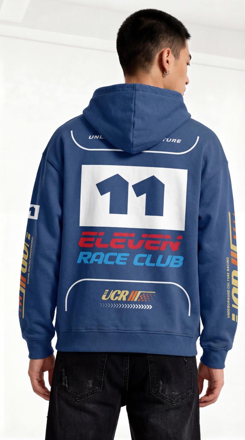 May include: A navy blue hooded sweatshirt with the number "11" in white on the back. The sweatshirt features the text "ELEVEN RACE CLUB" in red and blue, and other graphics. The sleeves have text and graphics in yellow and white.
