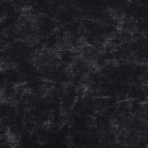 May include: Close-up of a black fabric with a textured, mottled appearance. The fabric has a dark base color with lighter, faded areas creating a distressed effect. The texture appears to be a woven material.