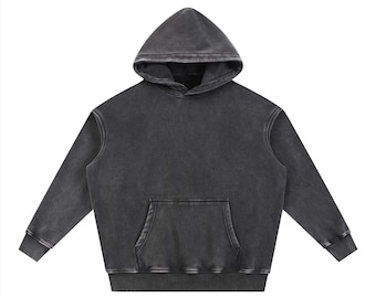 May include: A charcoal gray hoodie with a front pocket and a hood. The sweatshirt has long sleeves and a relaxed fit. The fabric has a washed, vintage appearance. The hoodie is displayed against a white background.