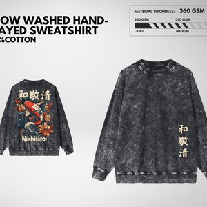 May include: A snow-washed, frayed sweatshirt made of 100% cotton. The dark gray sweatshirt features a Japanese-inspired design with a koi fish and floral elements on the back. The material thickness is 360 GSM.