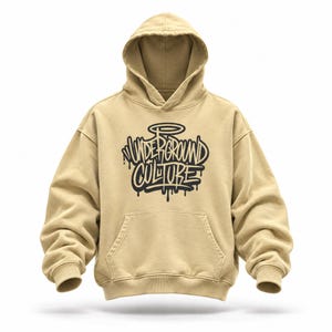 May include: A tan hooded sweatshirt featuring a front kangaroo pocket and long sleeves with ribbed cuffs. The chest displays a black graphic design with the text Underground Culture in a stylized graffiti font, complete with a halo above the lettering.