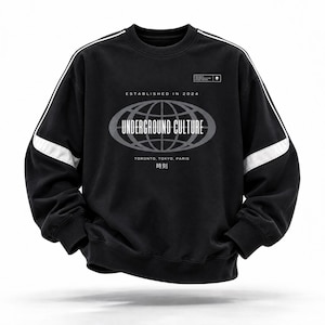 May include: A black long-sleeve sweatshirt featuring white piping along the shoulders and sleeves. The chest displays a graphic of a globe inside an oval with the text "ESTABLISHED IN 2024", "UNDERGROUND CULTURE", "TORONTO, TOKYO, PARIS", and "時刻".