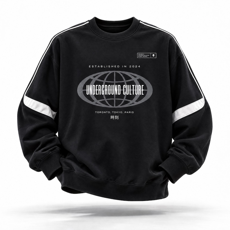 May include: A black long-sleeve sweatshirt featuring white piping along the shoulders and sleeves. The chest displays a graphic of a globe inside an oval with the text "ESTABLISHED IN 2024", "UNDERGROUND CULTURE", "TORONTO, TOKYO, PARIS", and "時刻".