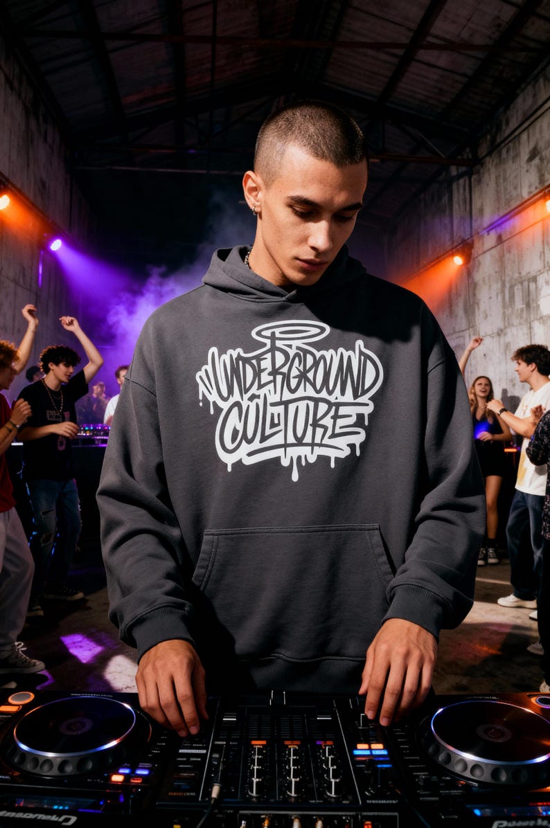 May include: A charcoal gray hooded sweatshirt featuring the text "UNDERGROUND CULTURE" in a white, stylized graffiti-inspired font with a halo graphic above the lettering, designed with long sleeves, a front kangaroo pocket, and ribbed cuffs.