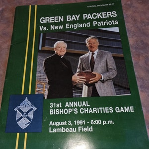 May include: A green and yellow program for the 31st Annual Bishop's Charities Game featuring the Green Bay Packers vs. the New England Patriots. The game is scheduled for August 3, 1991 at 6:00 p.m. at Lambeau Field.