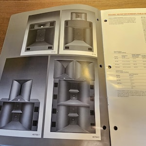 May include: A page from a catalog featuring black and white diagrams of sound reinforcement/theater systems. The diagrams showcase various speaker designs, with detailed illustrations of their internal components. Accompanying text provides specifications and technical details.