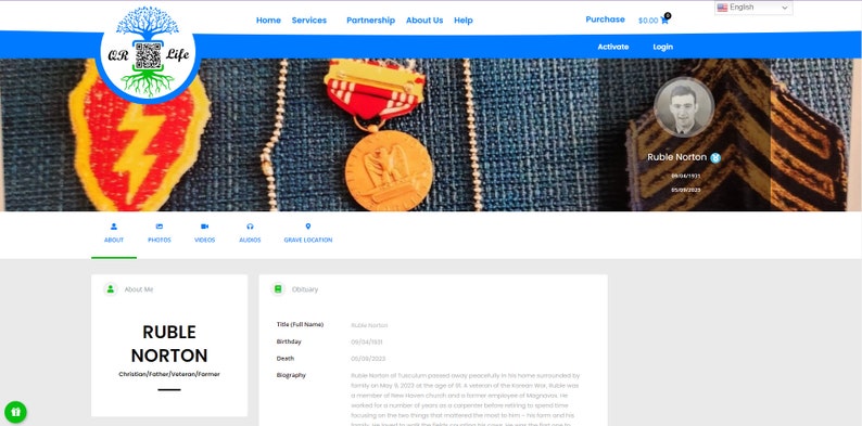 May include: A website homepage for a memorial service for Ruble Norton. The website features a photo of Ruble Norton, a blue and white color scheme, and a navigation bar with links to "About", "Photos", "Videos", "Audio", and "Grave Location".