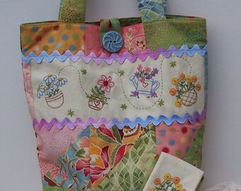 May include: A patchwork tote bag with a floral design and a matching zippered pouch. The bag is made of various fabrics in shades of pink, green, blue, and yellow. The pouch has a green and white polka dot pattern.