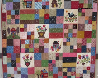 May include: A colorful patchwork quilt with a variety of applique designs, including houses, flowers, and birds. The quilt is made up of squares of different fabrics and colors, and the applique designs are sewn on top of the squares. The quilt is a beautiful example of traditional quilting.