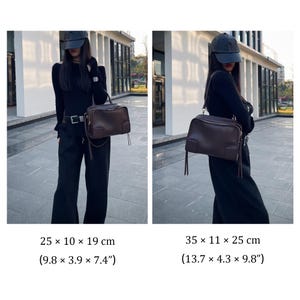 May include: A brown leather handbag with a rectangular shape, featuring a top handle and a shoulder strap. The bag measures 9.8 x 3.9 x 7.4 inches and 13.7 x 4.3 x 9.8 inches. It has a zipper closure and decorative tassels. The bag is shown in two different sizes.