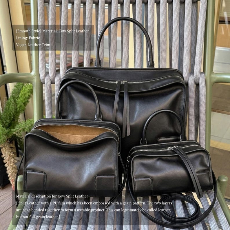 May include: A set of three black cow split leather bags, including a large tote with top handles, a medium satchel, and a small crossbody bag. The bags have silver zippers and are displayed on a chair.