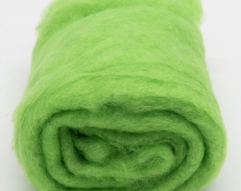 May include: A roll of bright green wool roving, a type of fiber used for felting and spinning.