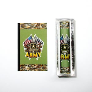 May include: A green and camouflage patterned rectangle with the words "U.S. ARMY" and "ARMY" in gold lettering. The rectangle is surrounded by a black border. Two American flags are crossed in the center of the rectangle. The rectangle is displayed in a clear plastic frame.