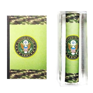 May include: A green, white, and gold United States Army seal on a green and brown camouflage background. The seal is surrounded by a gold circle with the words "United States Army" in gold letters. The seal is on a green and brown camouflage background. The seal is on a white background.