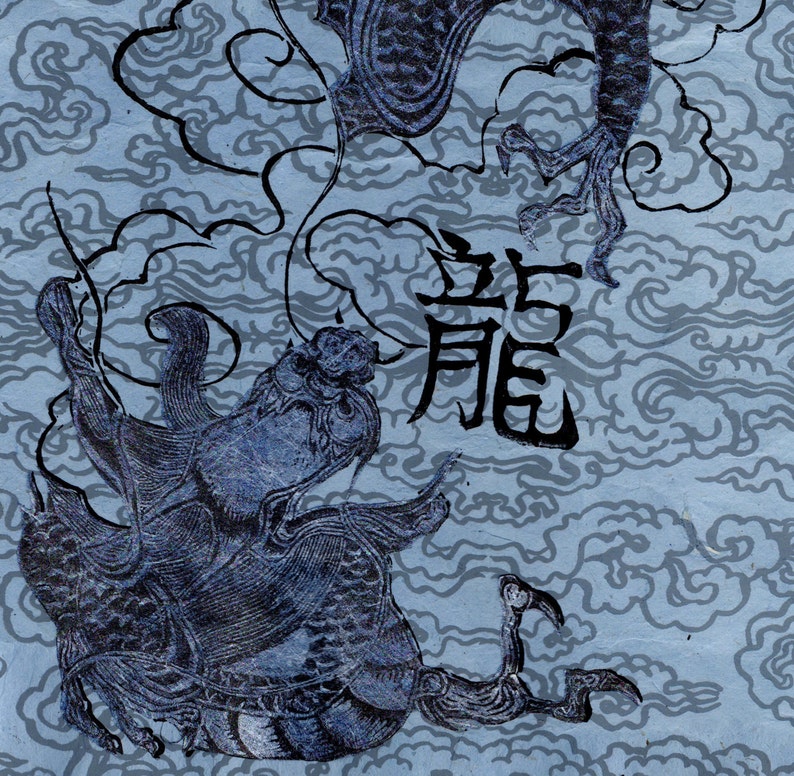 May include: A blue and black ink drawing of a dragon with the Chinese character for dragon, "龍", written in black ink. The dragon is depicted in a swirling cloud-like pattern.