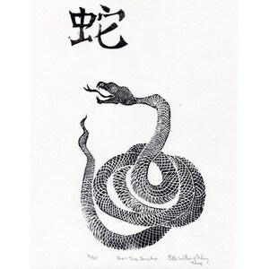 May include: Black and white linocut print of a snake with the Chinese character for "snake" above it. The print is titled "The Snake" and signed by the artist, Ella Willow-Allen.