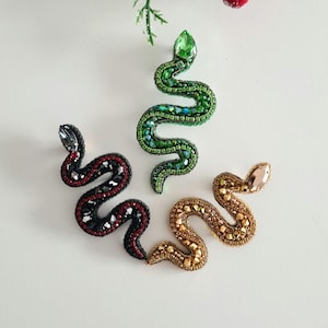 Brooch &quot;Snake&quot; made of beads and crystals. Available in gold and black. Symbol of the Year of the Snake. Stylish accessory for clothes.