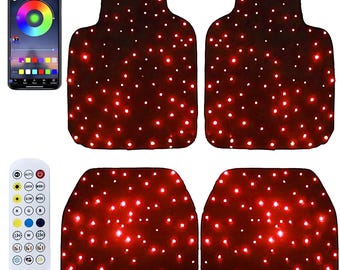 May include: Four car floor mats with a dark red base and many small, bright white lights. A smartphone shows a colour wheel interface, and a remote control is also included. The mats are designed for automotive use.