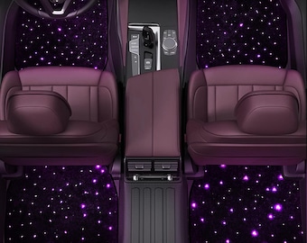 May include: Car interior with custom floor mats. The mats are black and covered in small, bright purple lights, resembling a starry night. The seats and interior are a deep burgundy colour, creating a luxurious aesthetic.