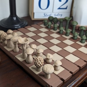 May include: A brown and white chessboard with mushroom-shaped chess pieces. The chessboard is made of wood and has a brown and white checkered pattern. The mushroom-shaped chess pieces are made of a light brown material and have a smooth, rounded surface. The chessboard is set up for a game of chess, with the white pieces on one side and the black pieces on the other.