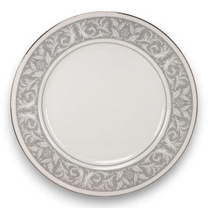 May include: White ceramic plate with a gray floral border and a thin gold rim. The plate features a detailed, repeating pattern of stylized leaves and flowers around the edge. A classic design for formal dining.