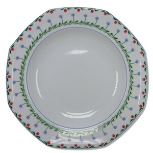 May include: A white octagonal soup bowl with a floral design in shades of pink, blue, and green. The design features small flowers and leaves around the rim of the bowl.