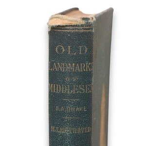 May include: A vintage green book with gold lettering on the spine. The title is "Old Landmarks of Middlesex" by S.A. Drake. The book is illustrated.