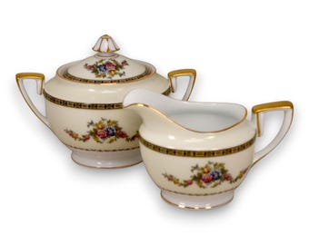 Conjunto de cremeira e açucareiro Noritake M Morimura, modelo Swag, com faixa amarela lisa e detalhes em dourado, 1933.