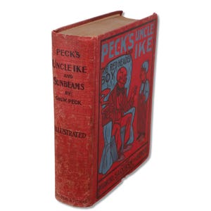 Könnte beinhalten: Ein rotes gebundenes Buch mit dem Titel Peck's Uncle Ike and Sunbeams von Geo. W. Peck. Das Cover zeigt eine schwarze Strichzeichnung eines Mannes und eines Jungen mit dem Text Peck's Uncle Ike and the Red Headed Boy. Der Buchrücken zeigt Titel und Autor.