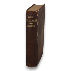 May include: A vintage, hardcover book with a brown leather cover. The title "Life of General Scott" is embossed in gold lettering on the spine. The book's edges show signs of age, adding to its antique appearance.