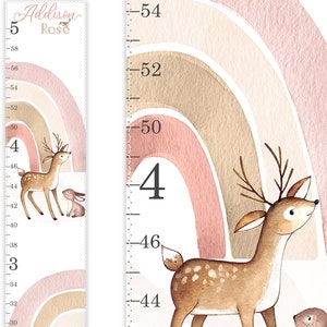 May include: A vertical growth chart featuring the name Addison Rose at the top. The design includes watercolor illustrations of a deer and a rabbit against a soft pink and tan rainbow background, with imperial measurements in inches marked along the side.