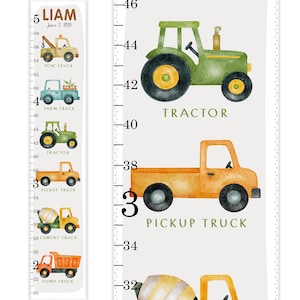 May include: A children's growth chart featuring watercolor illustrations of various trucks and vehicles, including a tow truck, farm truck, tractor, pickup truck, cement truck, and dump truck. The chart includes a name and date at the top, with measurements in inches.