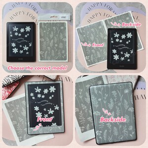 May include: A black Kindle e-reader with a floral design on the screen, featuring white flowers and the text "I am reading." The image also shows a gray cover with a matching floral pattern and the text "Choose the correct model."