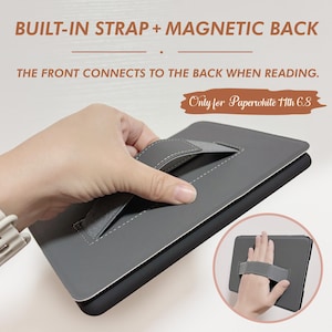 May include: Gray e-reader case with a built-in strap and magnetic back. The case has a stitched strap that can be used to hold the e-reader. The text "Only for Paperwhite 11th 6.8" is visible on the case.