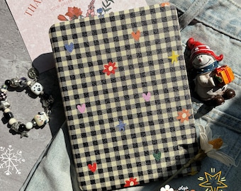 May include: A black and cream checkered phone case decorated with colorful embroidered hearts, stars, and flowers. The case is on a pair of blue jeans. A snowman figurine and a bracelet are also in the image. The text "THANK YOU SO MUCH!" is visible.