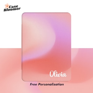 May include: A pink and purple ombre tablet case with the name "Olivia" printed in white. The case has a textured surface and says "Free Personalization" at the bottom.