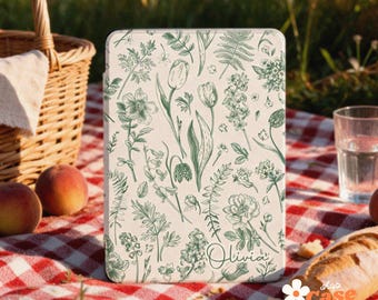 May include: A rectangular e-reader case featuring a cream-colored background with a detailed green botanical print of various flowers, leaves, and stems. The name Olivia is written in a cursive script in the bottom right corner.
