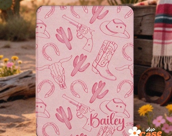 May include: A rectangular e-reader case with a light pink background featuring a repeating pattern of dark pink line art including cowboy boots, hats, revolvers, horseshoes, cacti, and steer skulls, with the name Bailey printed in script.