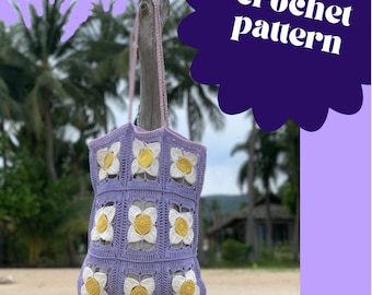 May include: A handmade, lavender crochet tote bag with white and yellow flower accents. The bag has a rectangular shape and a pink strap. The words "crochet pattern" are in white text on a purple background.