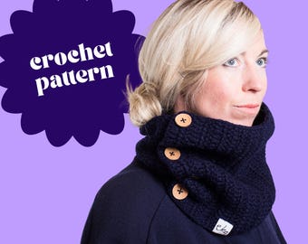 May include: A navy blue crochet cowl with three wooden buttons. The cowl is worn around the neck and has a small white label with the text "eka". The image also includes a purple background with the words "crochet pattern".